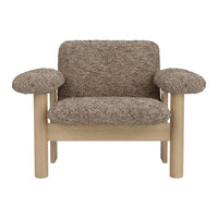 Brown textured upholstery armchair with light wooden legs and rounded armrests. Stylish and modern design.