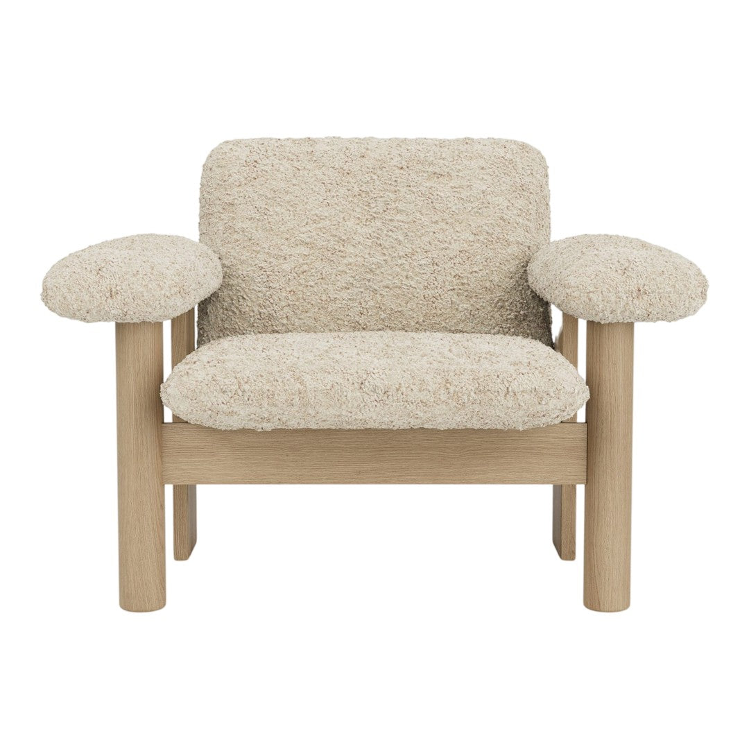 Textured cream upholstery with light wooden frame; plush, rounded armrests for a cozy, modern look.