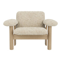 Textured cream upholstery with light wooden frame; plush, rounded armrests for a cozy, modern look.