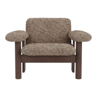 Brown textured armchair with soft, shaggy upholstery and dark wooden frame. Cozy and inviting design.