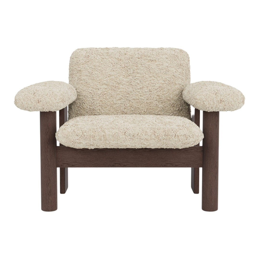Beige textured upholstery with brown wooden frame, featuring a cozy, modern design and rounded armrests.
