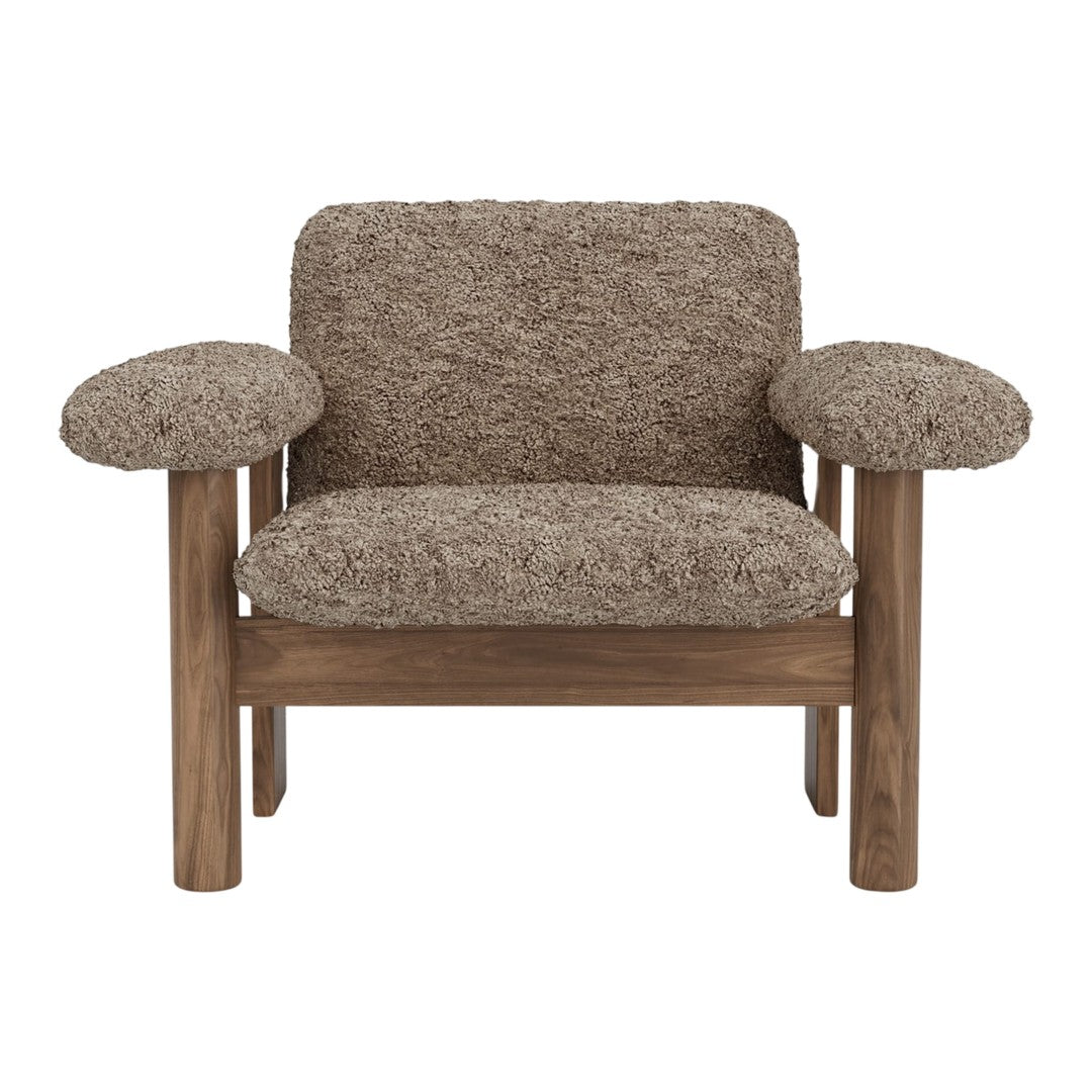 Brown textured armchair with soft, fluffy upholstery and wooden frame, perfect for cozy interiors.