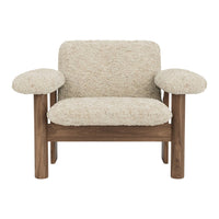 Beige textured upholstery with plush, rounded armrests and warm wooden frame. Cozy, modern accent chair design.