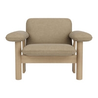 Beige upholstered armchair with soft rounded armrests and light wooden legs, featuring a minimalist design.