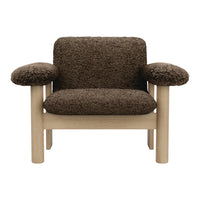 "Cozy brown faux fur armchair with soft rounded arms and light wood legs, ideal for modern living spaces."