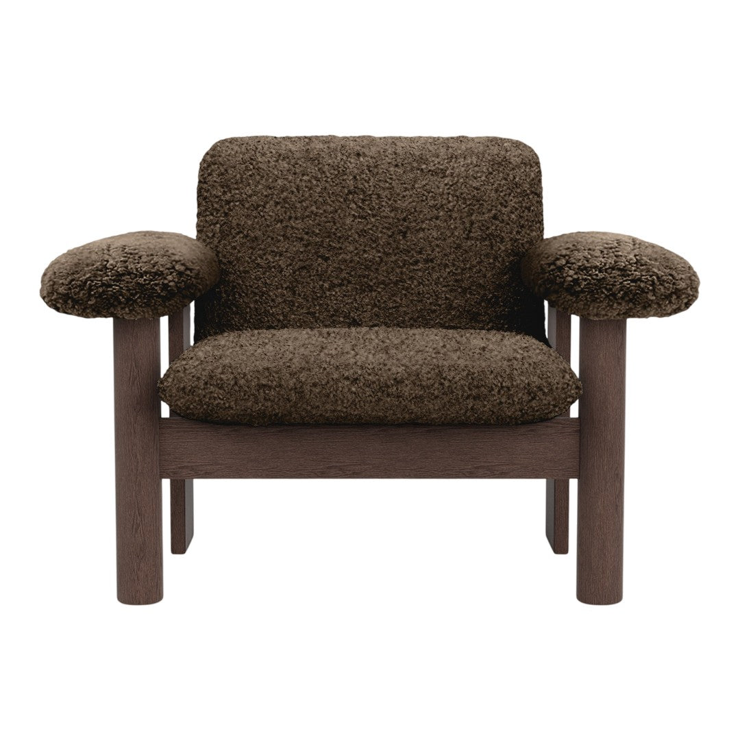 Brown textured chair with plush, soft fabric upholstery and a solid wood frame. Cozy and stylish design.