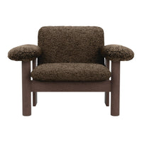 Brown textured chair with plush, soft fabric upholstery and a solid wood frame. Cozy and stylish design.