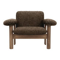 Brown textured fabric armchair with wooden legs, featuring a cozy and stylish design. Perfect for modern interiors.