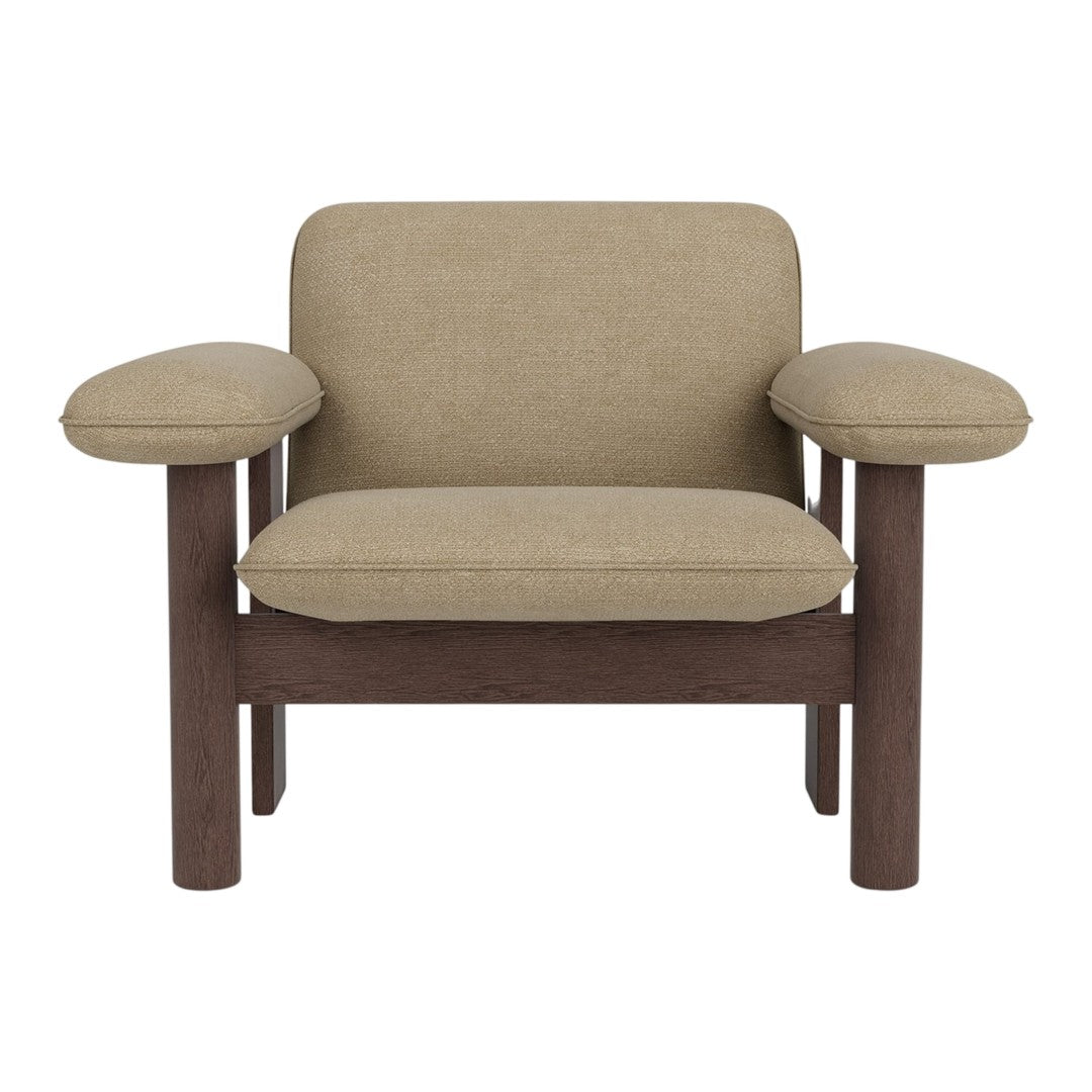 Beige upholstered chair with rounded arms and dark wooden frame, showcasing a modern and minimalistic design.