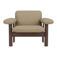 Beige upholstered chair with rounded arms and dark wooden frame, showcasing a modern and minimalistic design.