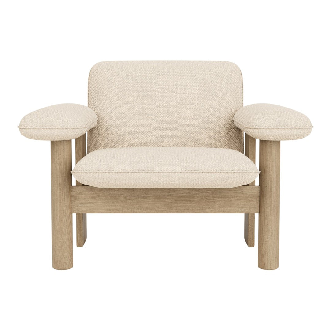 Beige upholstered armchair with a minimalist design and natural wood frame, featuring smooth lines and no patterns.