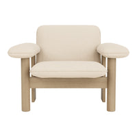 Beige upholstered armchair with a minimalist design and natural wood frame, featuring smooth lines and no patterns.
