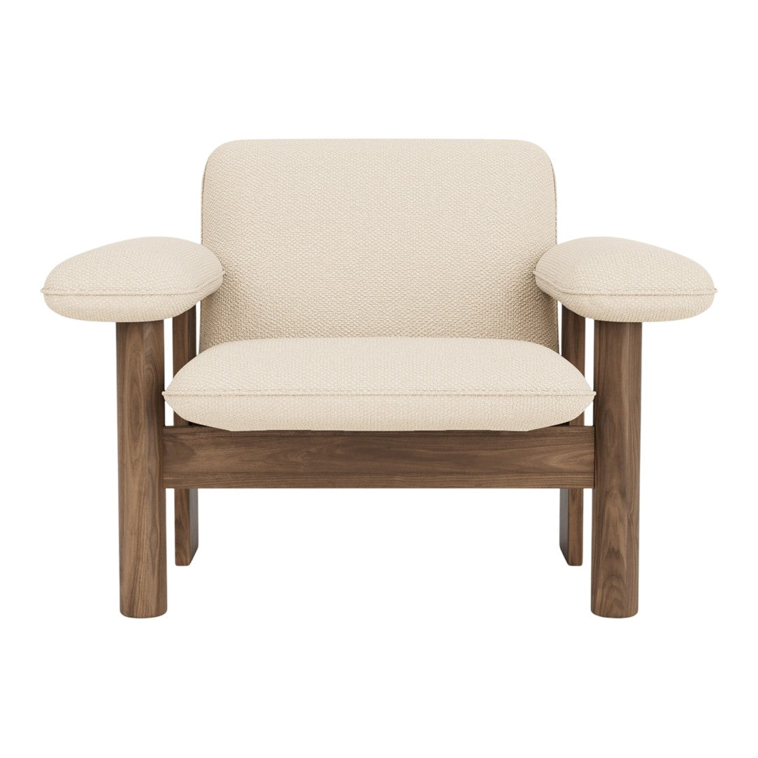 Cream-colored armchair with natural walnut wood legs and arms, featuring a simple, modern design.
