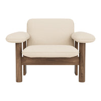 Cream-colored armchair with natural walnut wood legs and arms, featuring a simple, modern design.
