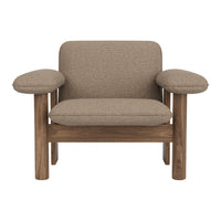 Brown upholstered armchair with rounded arms and wooden legs, featuring a textured fabric pattern.