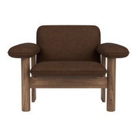 Brown upholstered chair with rounded arms and a wooden frame, featuring a minimalist design.