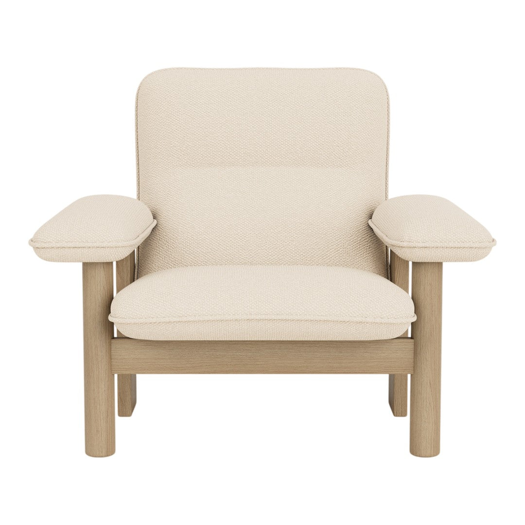 Beige upholstered armchair with a minimalist design and natural wooden legs, featuring a smooth, solid color pattern.