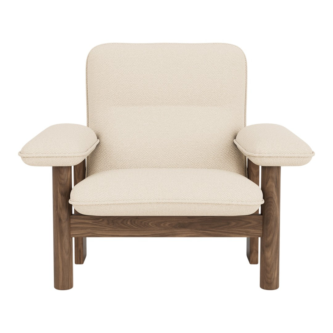Light beige upholstered chair with a minimalist design and wooden accents.