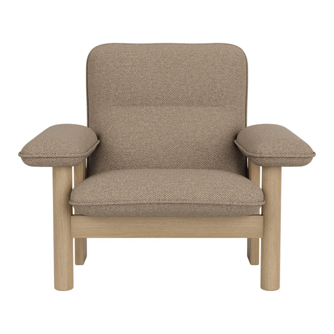 Beige upholstered armchair with smooth, minimalist design and wooden legs, featuring a simple, modern aesthetic.