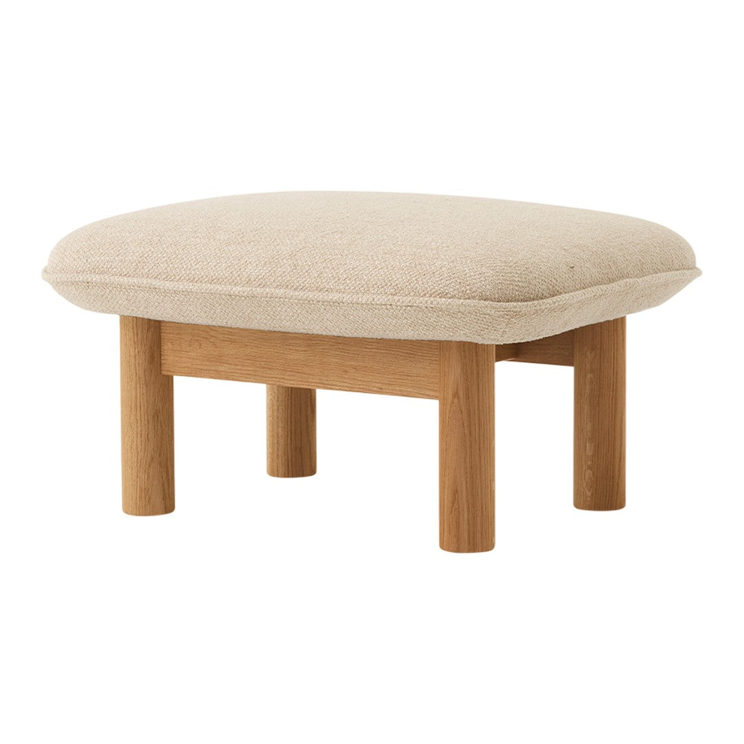 Beige tufted ottoman with a wooden frame, featuring a smooth, minimalist design and soft upholstery.
