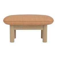 Tan leather ottoman with a smooth, rounded top and light wooden legs, featuring a minimalist design.