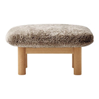 Soft beige fluffy cushion with oak legs, featuring a rounded design for a cozy, modern look.