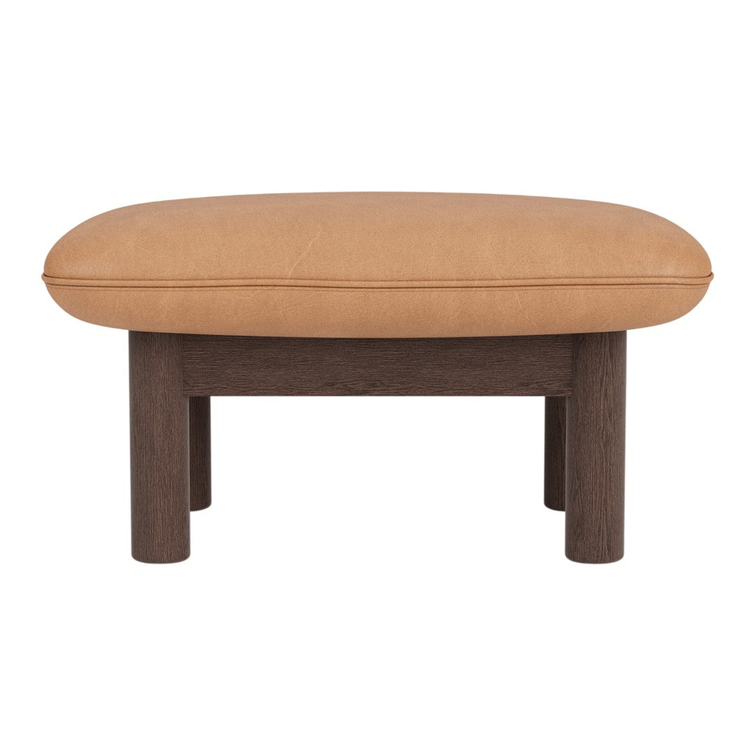Tan oval cushion on a dark wood base, featuring a smooth, minimalistic design. Perfect for modern interiors.
