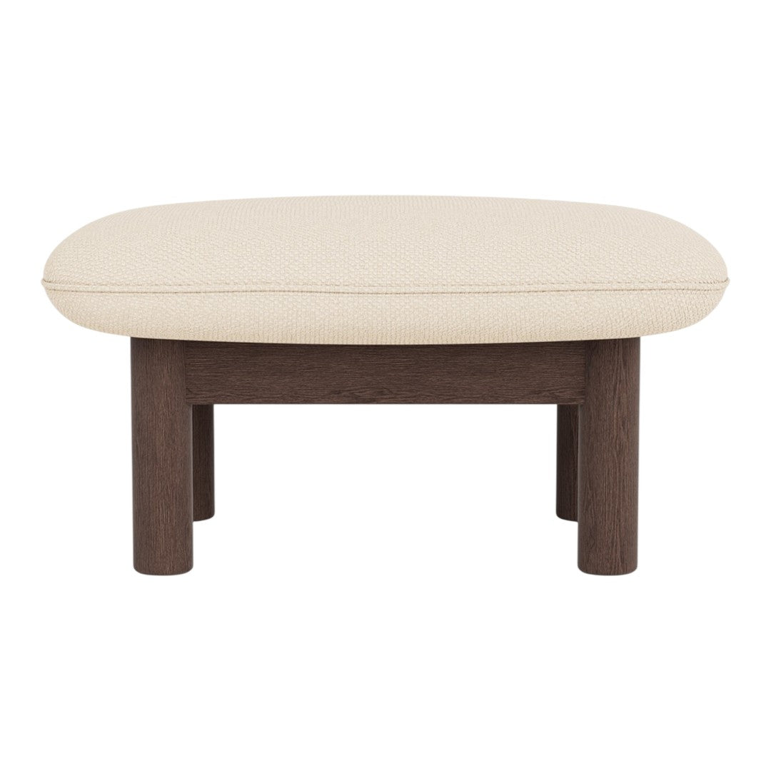 Beige cushioned ottoman with a sleek dark wood frame, featuring a simple, modern design.
