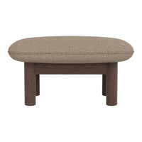 Brown oval ottoman with textured fabric and wooden legs, perfect for stylish living room decor.