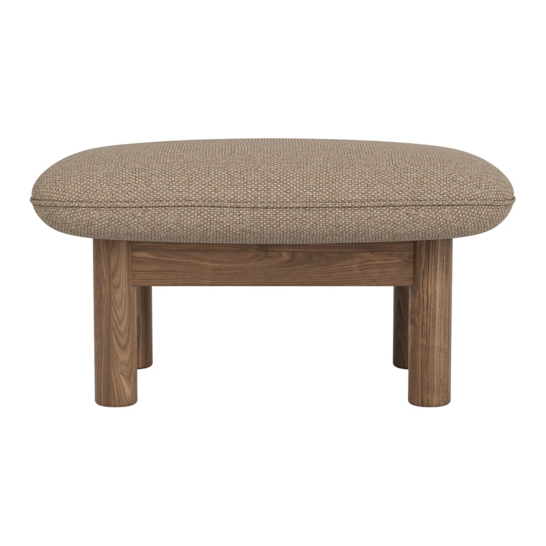 Brown upholstered ottoman with a rounded shape and wooden legs, showcasing a textured fabric pattern.