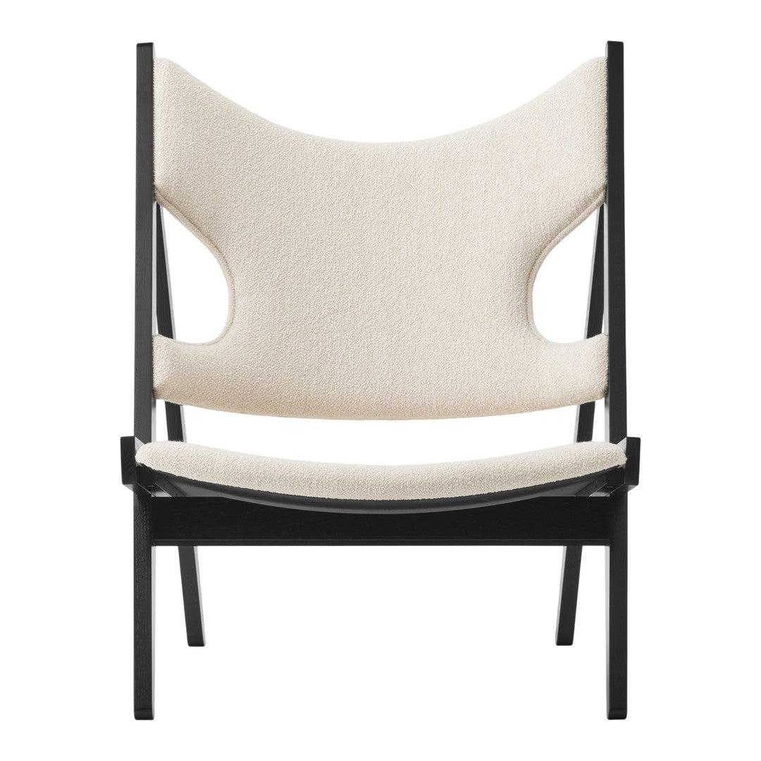 Neutral beige upholstery with a minimalist black frame; modern and stylish chair design.
