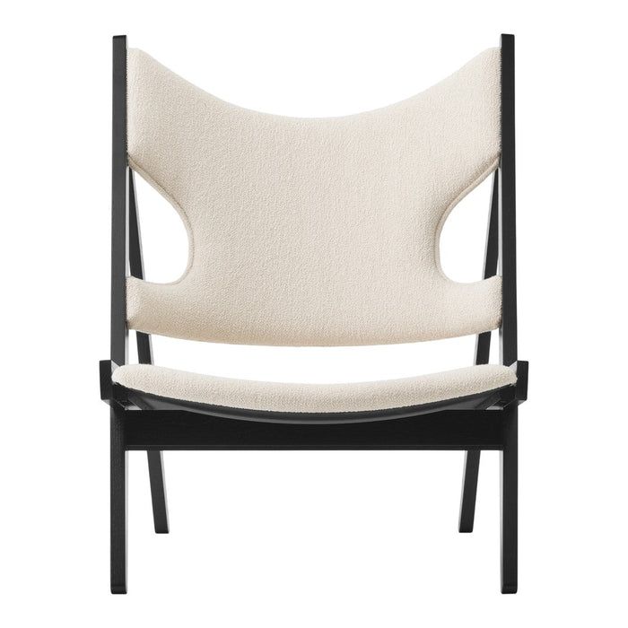 Neutral beige upholstery with a minimalist black frame; modern and stylish chair design.