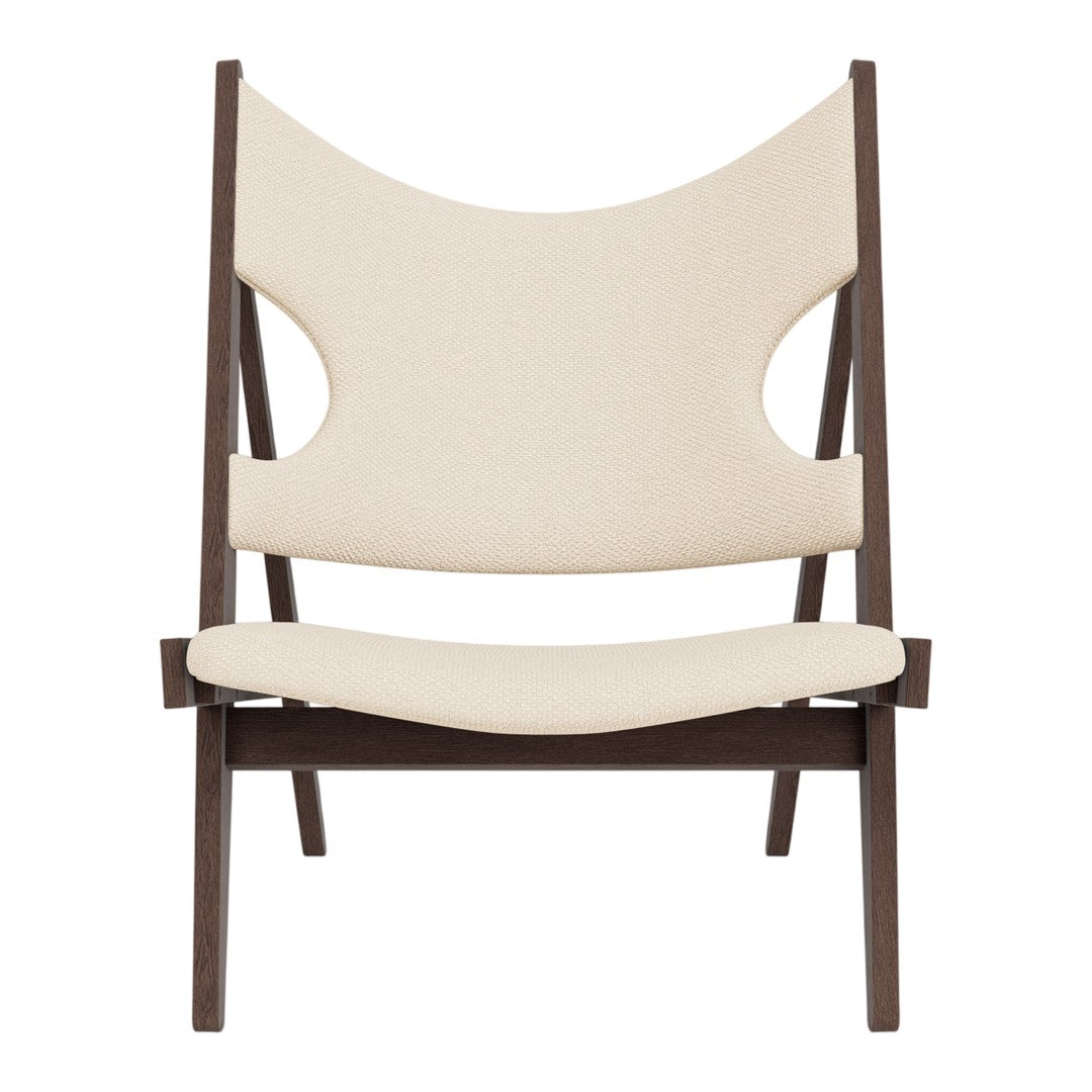 Beige fabric chair with a unique open-back design and dark wood frame, creating a modern, minimalist aesthetic.