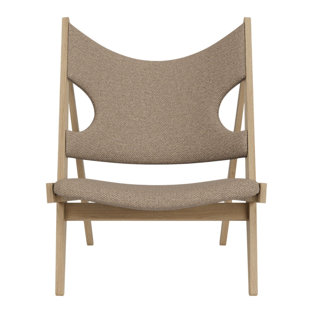 Brown fabric armchair with a smooth texture and cut-out design, set on a light wood frame.