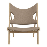 Brown fabric armchair with a smooth texture and cut-out design, set on a light wood frame.