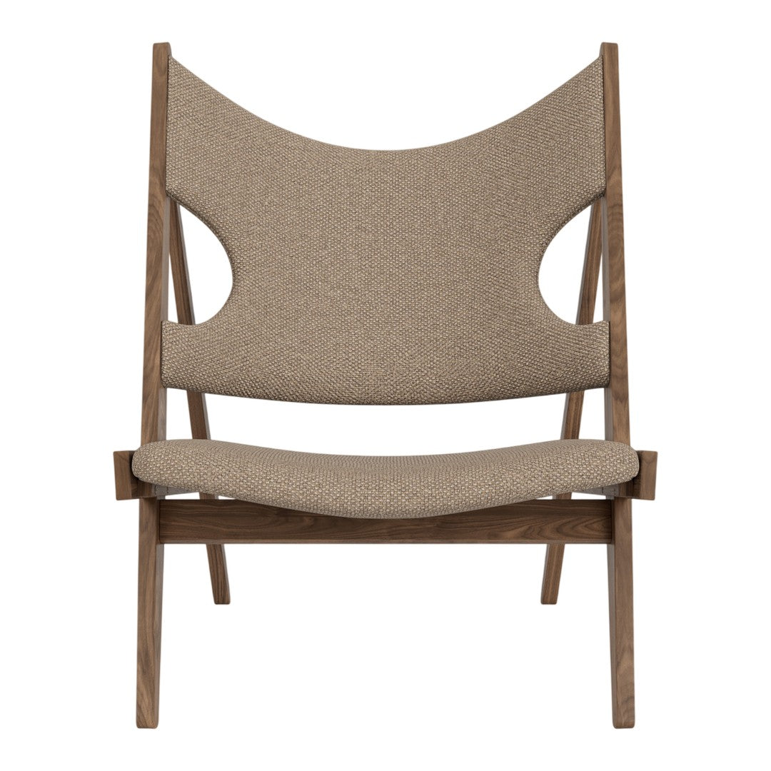 Brown upholstered chair with a unique cut-out pattern and a modern wooden frame. Perfect for contemporary decor.