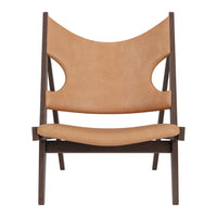 Tan leather chair with a minimalist design and dark wood frame featuring smooth lines and a modern silhouette.