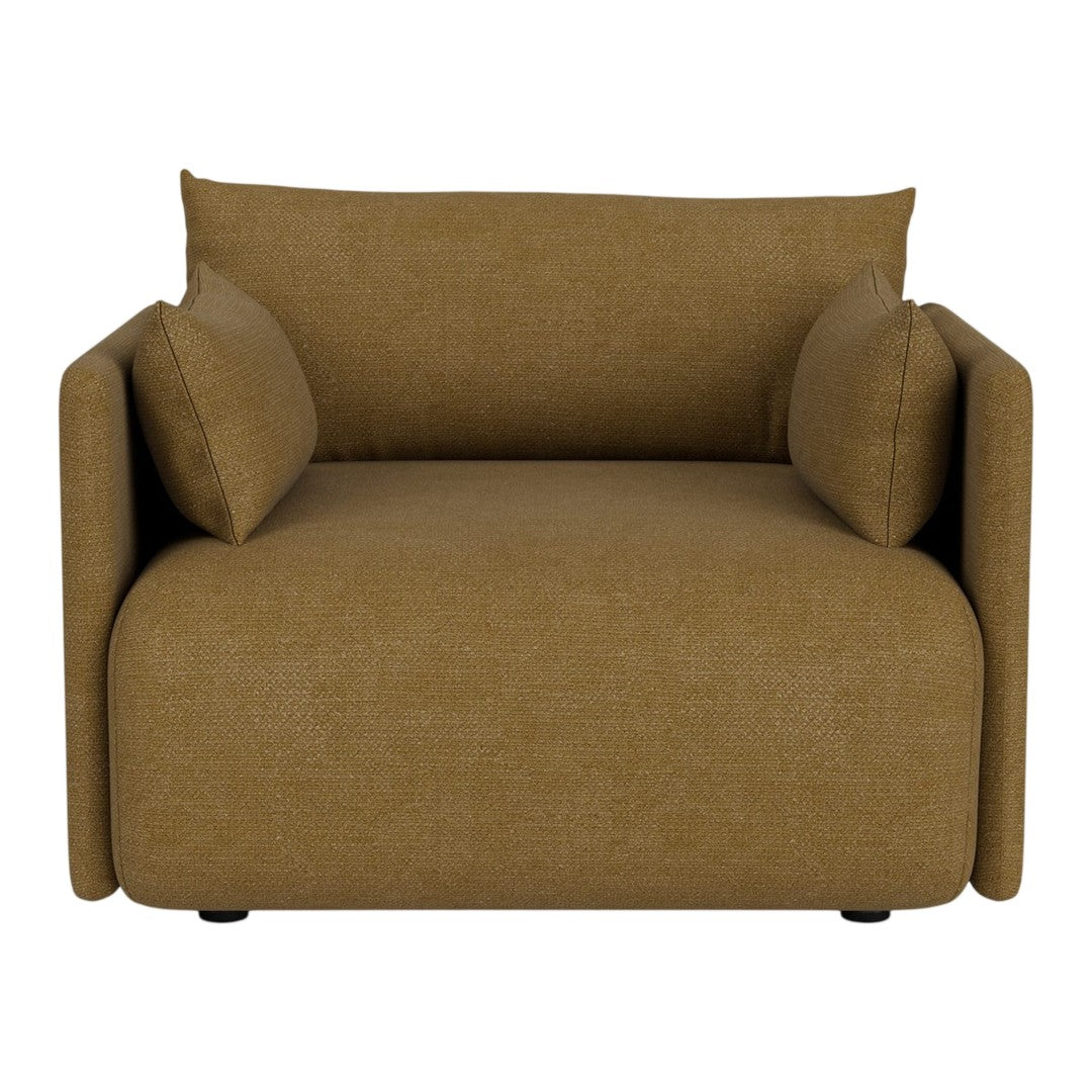 Tan upholstered modern chair with two matching pillows and a minimalist design, perfect for contemporary spaces.