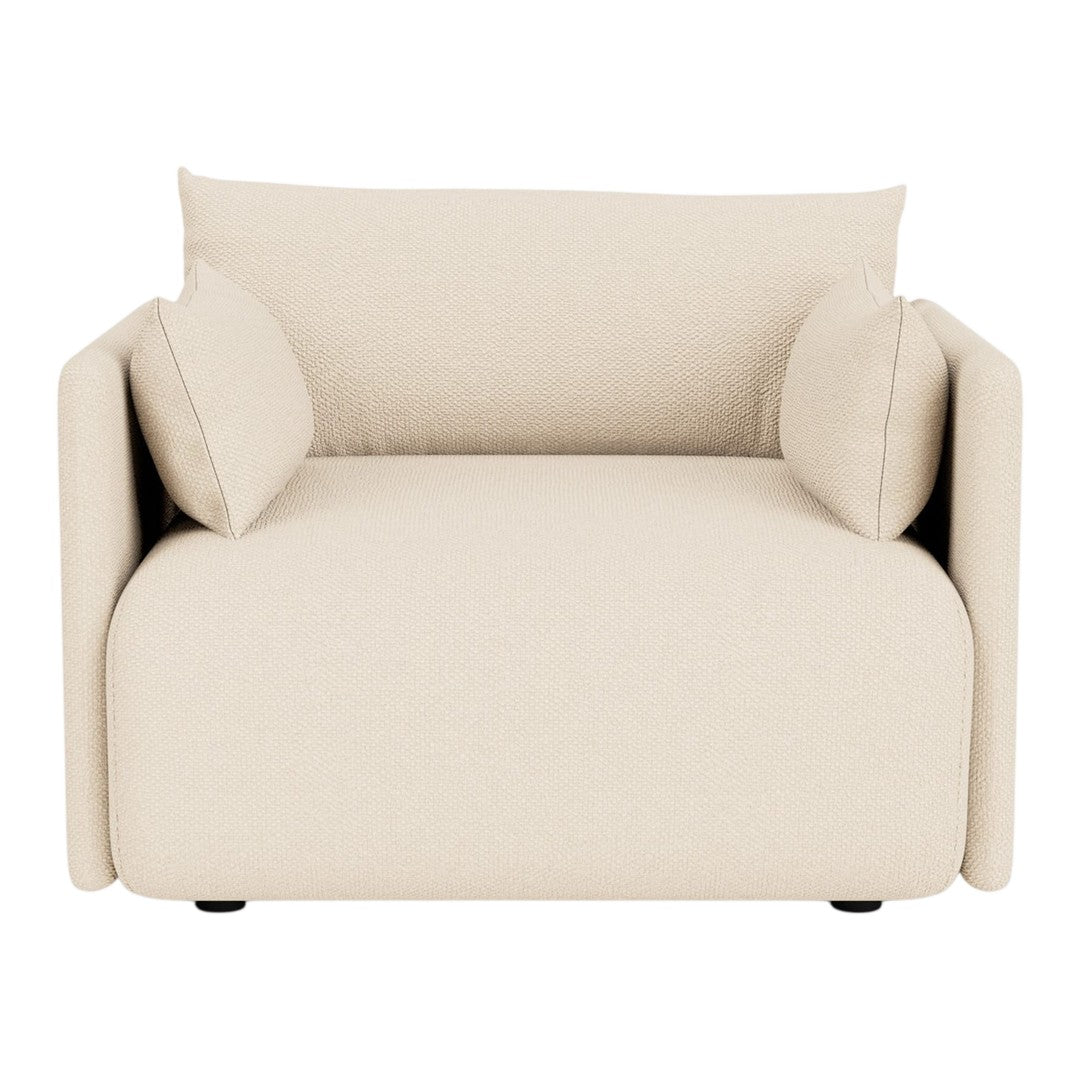 Beige upholstered armchair with two matching cushions and a smooth, modern design. Perfect for any stylish living space.