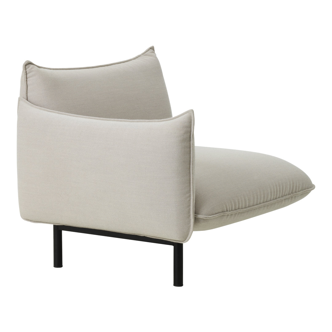 Modern cream lounge chair with a sleek black metal frame and soft, textured upholstery. Perfect for minimalist decor.