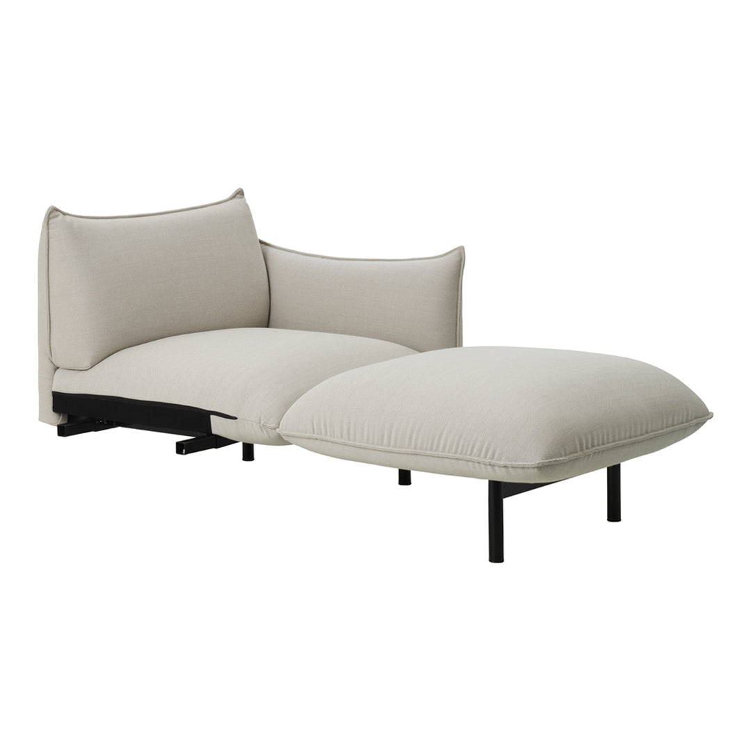 Beige two-tone chaise lounge with smooth fabric and sleek black metal legs, featuring minimalistic design.