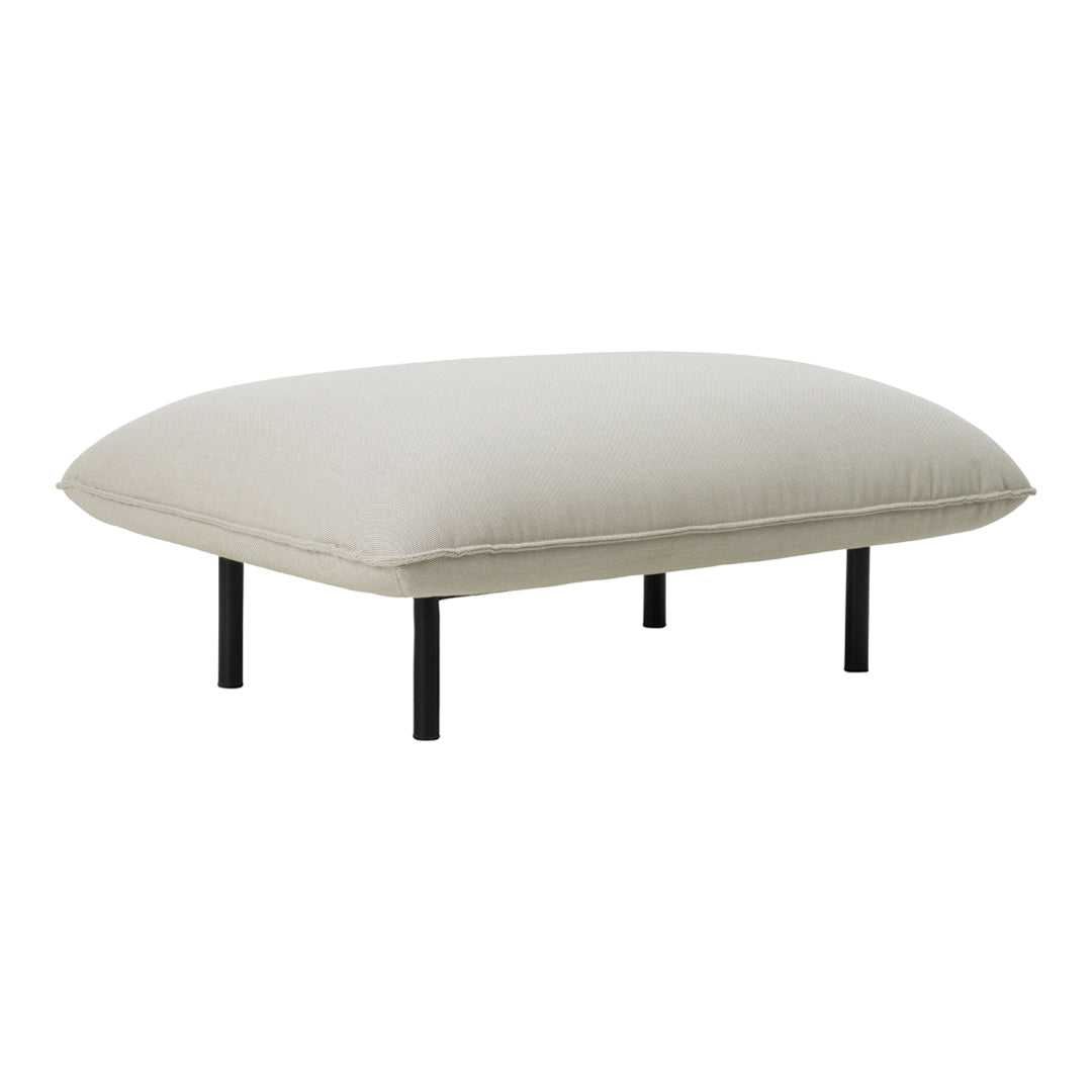 Light beige cushion with a smooth texture, supported by sleek black metal legs, minimalistic and modern design.