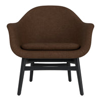Brown upholstered lounge chair with a smooth, rounded design and black wooden legs. Perfect for modern interiors.