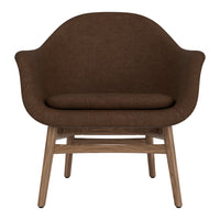 Brown upholstered chair with a smooth, rounded design and natural wooden legs. Ideal for modern interiors.