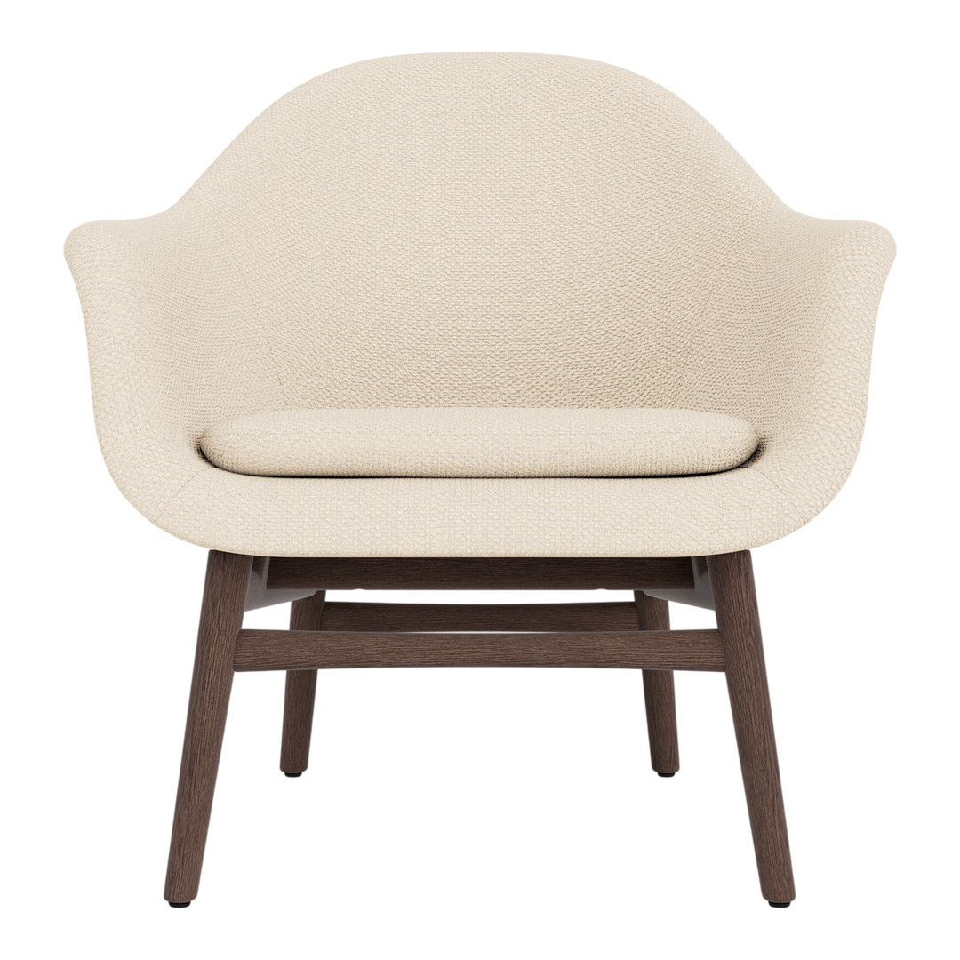 Cream-colored upholstered chair with a smooth, rounded design and dark brown wooden legs.