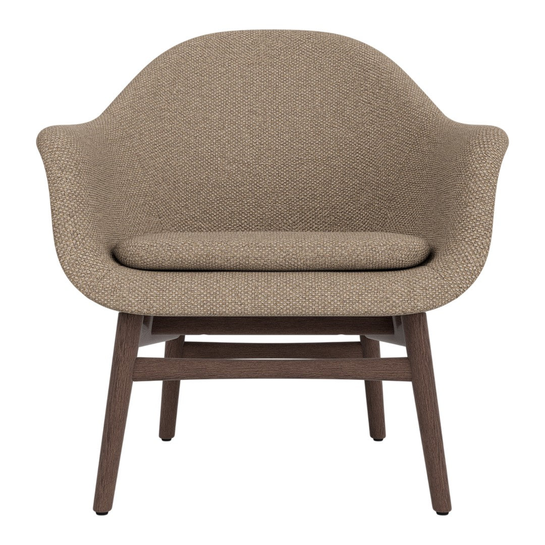 Brown textured armchair with a smooth, rounded design and dark wooden legs, perfect for modern decor.