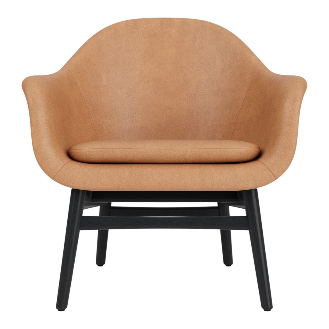 Tan leather armchair with a smooth finish, featuring a sleek black wooden base. Modern and minimalist design.