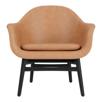 Tan leather armchair with a smooth finish, featuring a sleek black wooden base. Modern and minimalist design.
