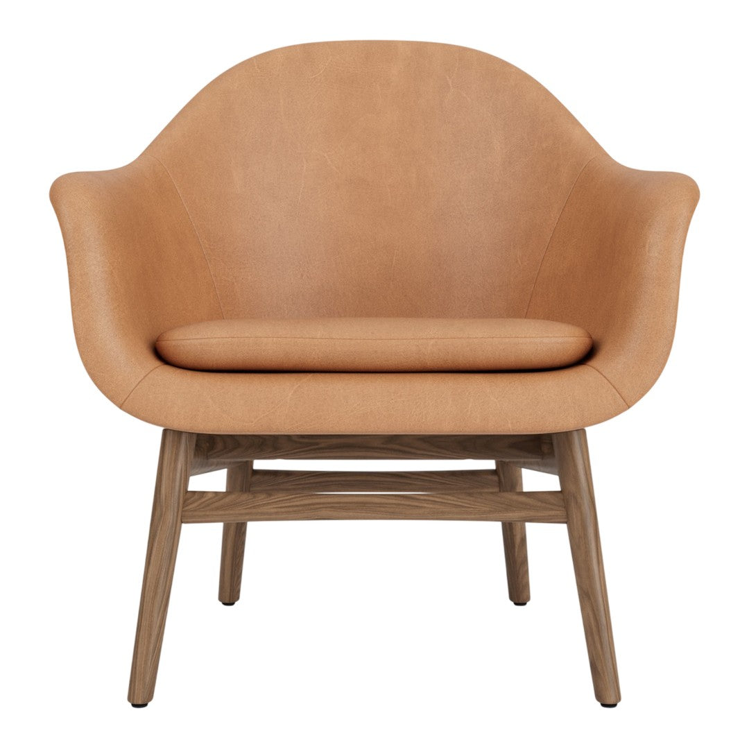 Tan leather armchair with a smooth finish and natural wood legs, offering a modern, minimalist design.