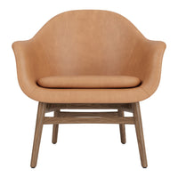 Tan leather armchair with a smooth finish and natural wood legs, offering a modern, minimalist design.